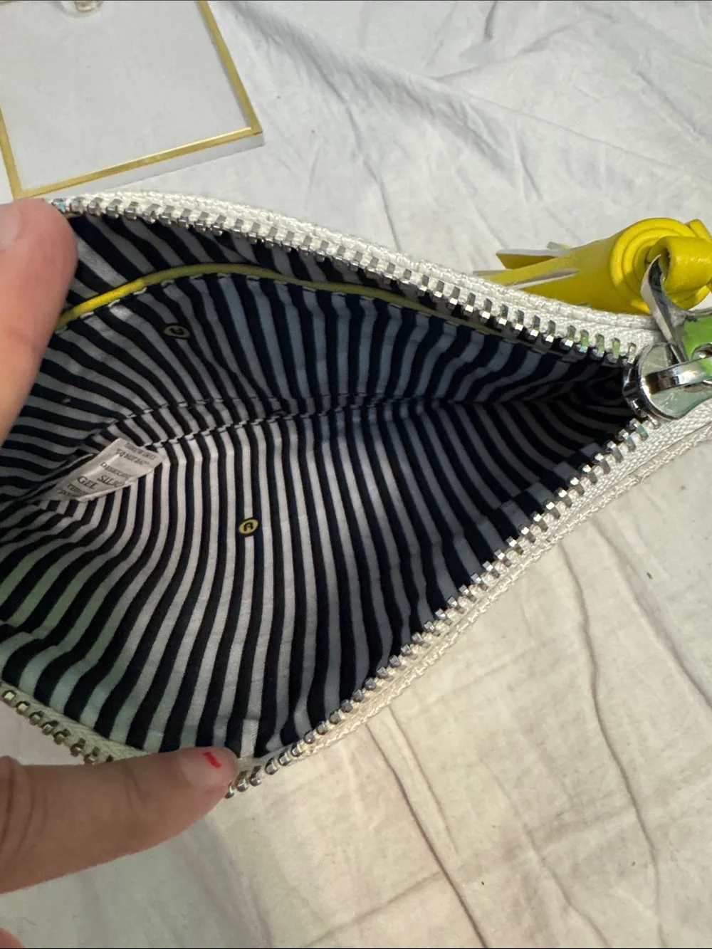 White Daisy-Embroidered Wristlet Clutch with Yellow Tassel